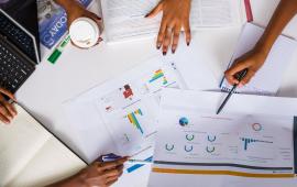 People at a meeting going over finances and reports.
