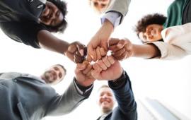 People fist bumping, teamwork