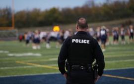 School Resource Office watching over a high school football game