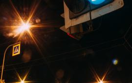 Traffic signal with streetlights in the background at nighttime