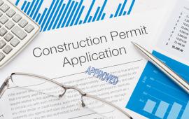 Image of Construction Permit Application, a pen, glasses and calculator