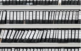 Binders with files on shelves