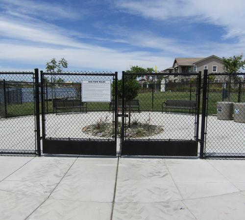 Cyclone Gate Entrance to River Islands Dog Park with Park Rules Posted