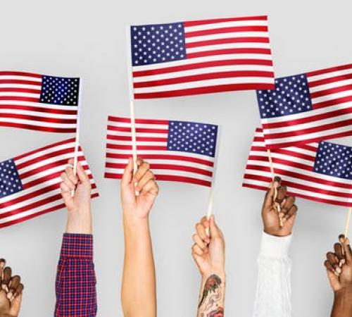 American Flag held by various human hands to express diveristy