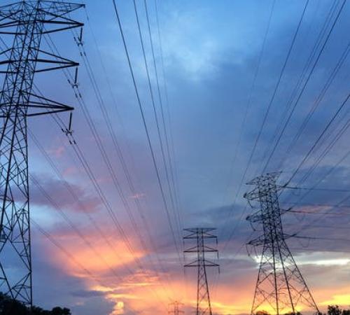 Power lines under cloudy sky