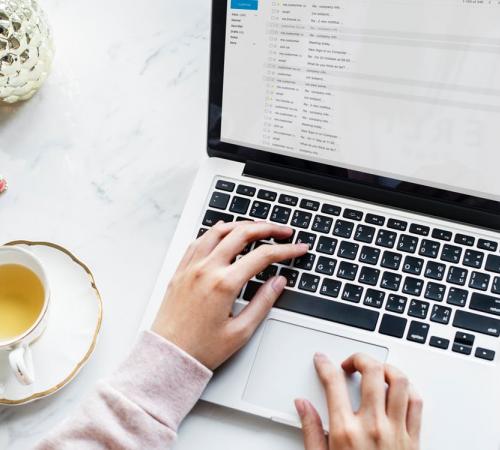 person on laptop and tea