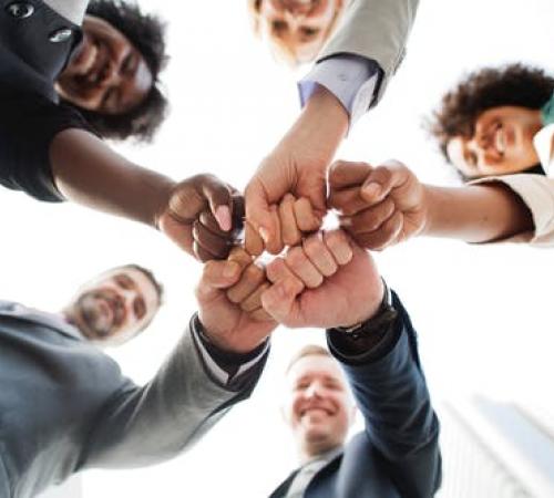 People fist bumping, teamwork