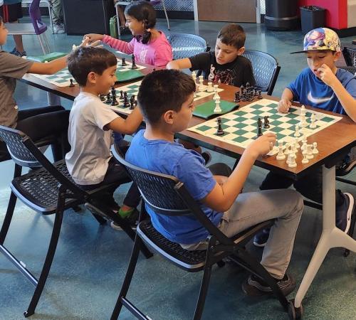 Kids play chess at chess camp 