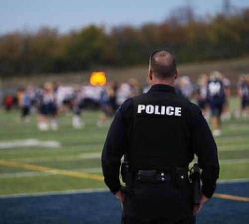 School Resource Office watching over a high school football game