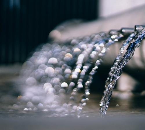 Water draining from pipes into larger body of water