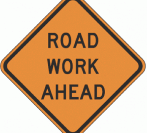 Road work ahead orange sign with black text