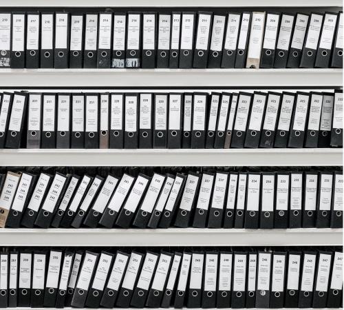 Binders with files on shelves