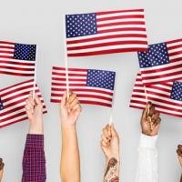 American Flag held by various human hands to express diveristy