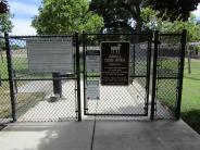 Cyclone entrance gate to small dog area at Lathrop Dog Park at River Park South