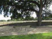 Agility poles and ramp inside small dog area at Lathrop Dog Park at River Park South