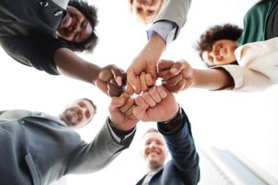 People fist bumping, teamwork