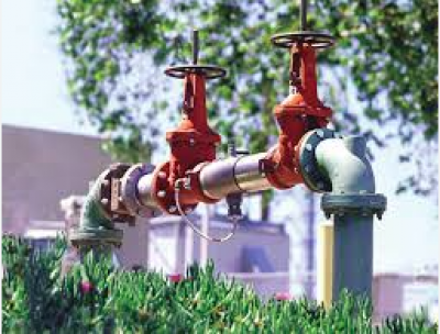 Backflow Device in industrial area surrounded by landscape