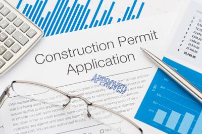Image of Construction Permit Application, a pen, glasses and calculator