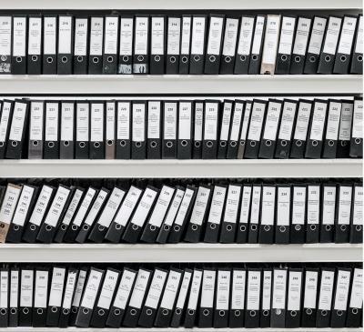 Binders with files on shelves