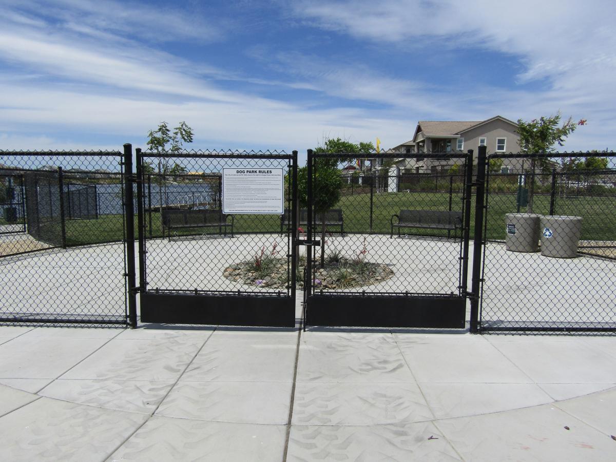 Cyclone Gate Entrance to River Islands Dog Park with Park Rules Posted