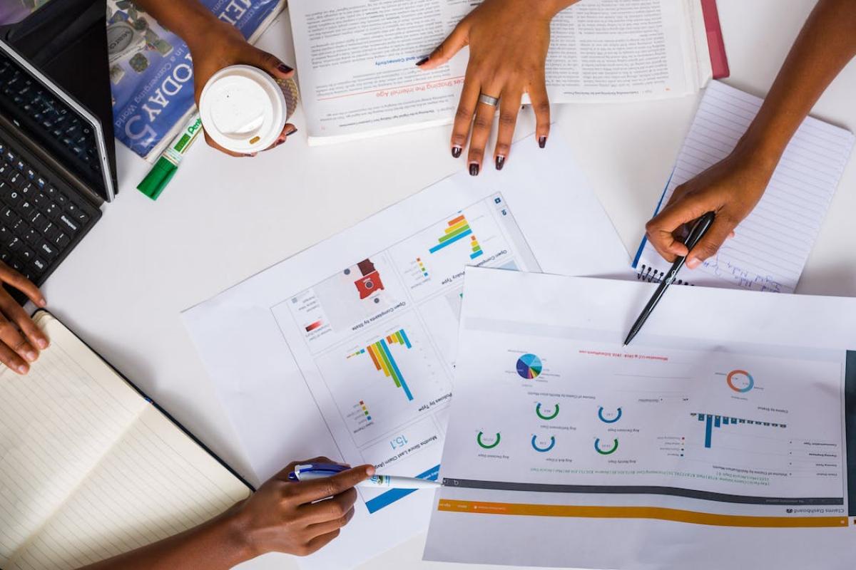 People at a meeting going over finances and reports.