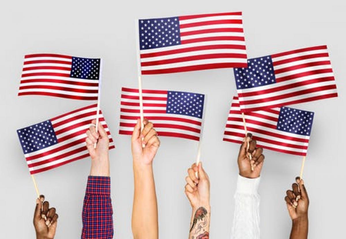 American Flag held by various human hands to express diveristy