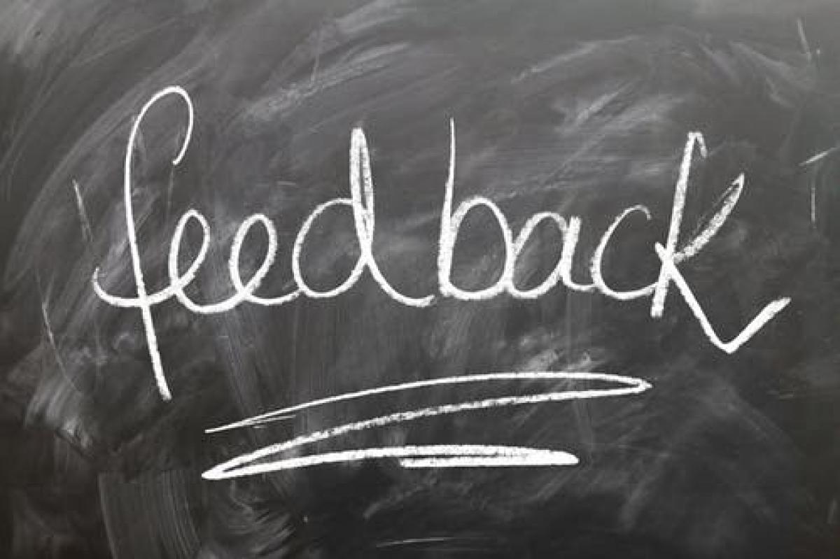 The word "Feedback" written on a chalkboard with white chalk