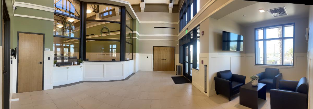 A picture taken from ground level that faces the LPD Lobby showing black chairs with multiple doors and glass windows.