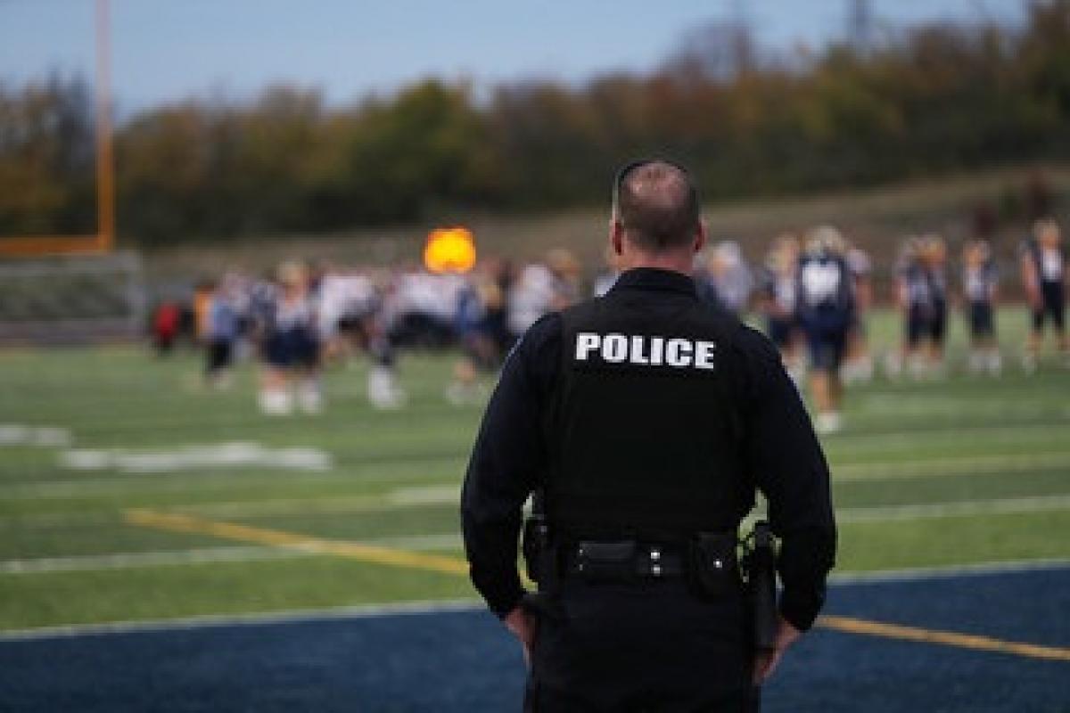 School Resource Office watching over a high school football game