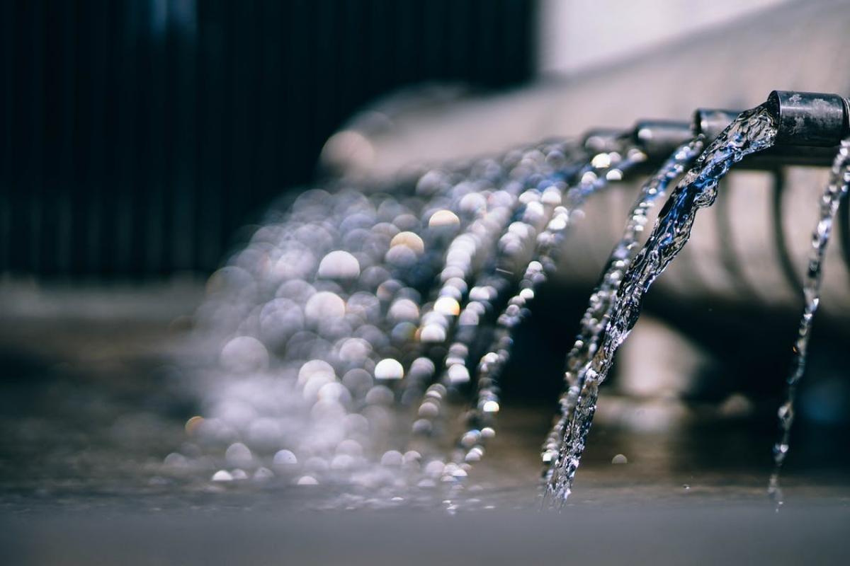 Water draining from pipes into larger body of water